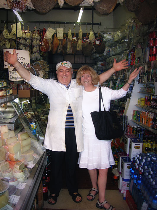 Judy Capellino and a Deli Owner in Spoleto, Italy